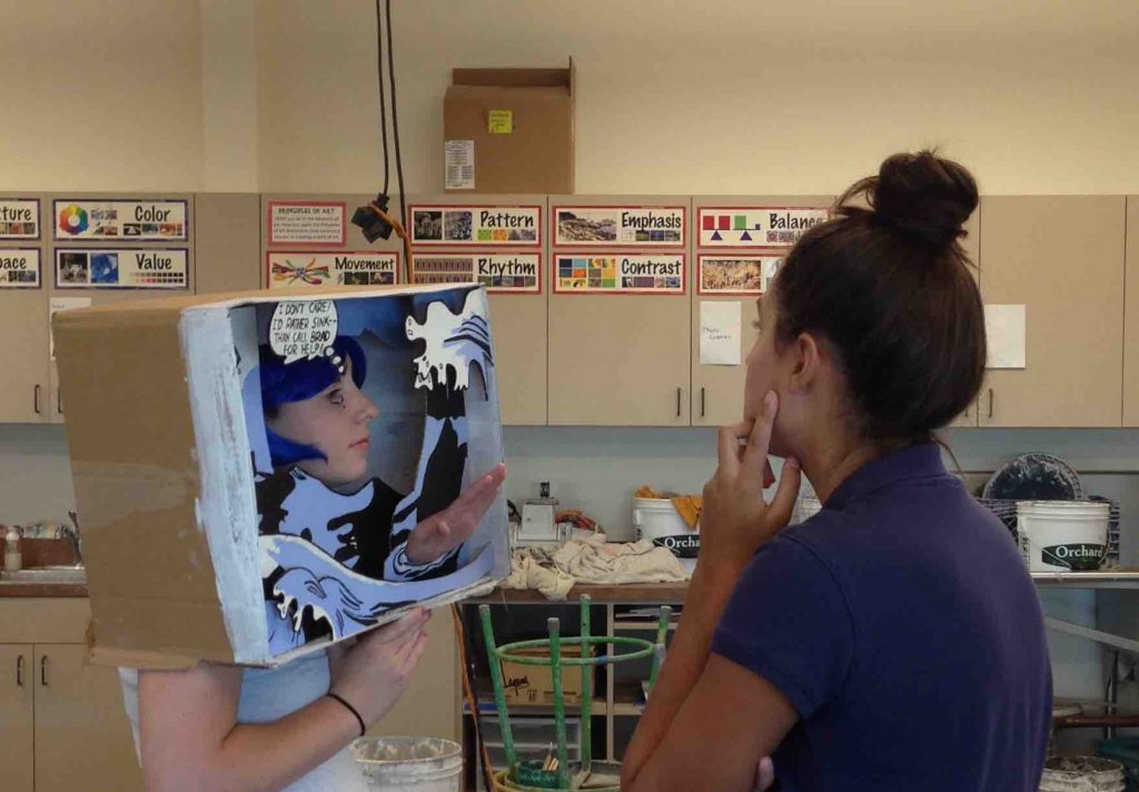 Emily Gray ’17, Sculpture 3, works on final touches for her Remake of Roy Lichtenstein’s Drowning Girl with cousin Madeline Gray ’18 as her model.